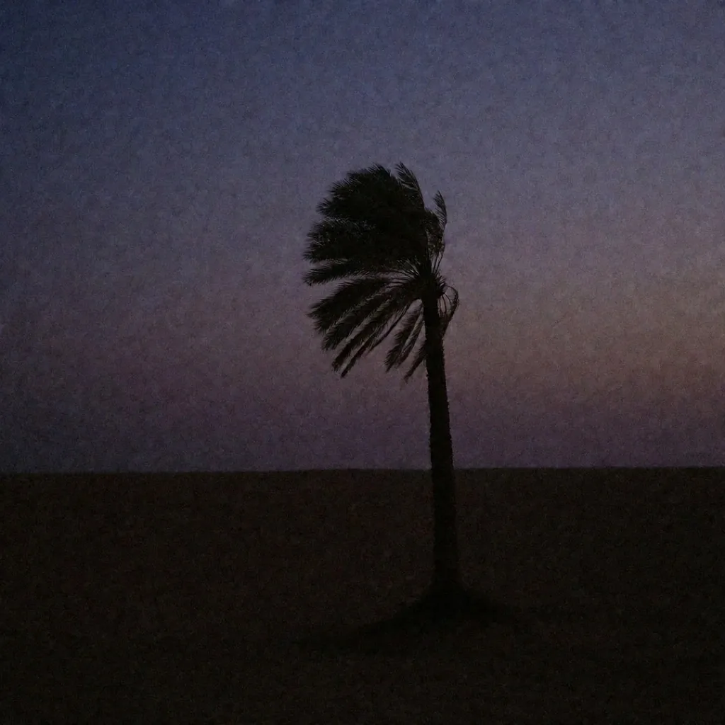 Palm silhouette against dusk sky